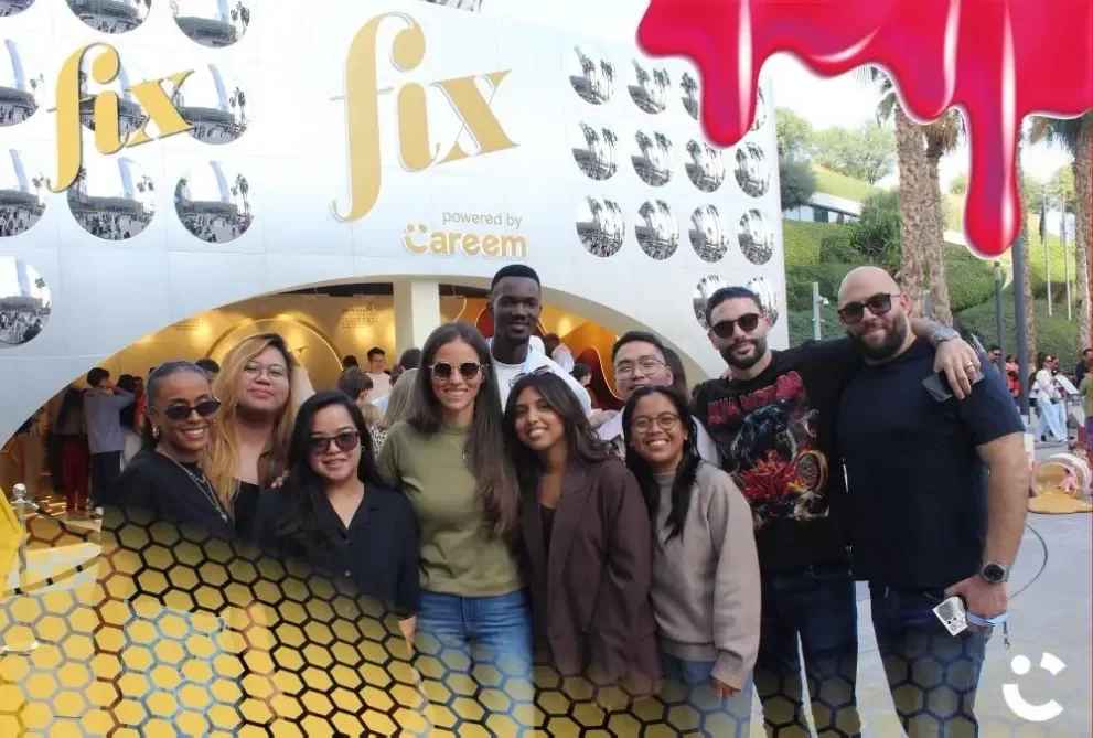 The Fix team holding a branded gift bag